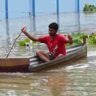 টিনের ডোঙ্গায় চড়ে পারাপার করছেন স্থানীয় মানুষ
